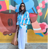 Blue striped dress by Poppy & Co featuring soft vertical stripes, lightweight fabric, and a relaxed, elegant summer fit.
