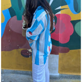 Blue striped dress by Poppy & Co featuring soft vertical stripes, lightweight fabric, and a relaxed, elegant summer fit.
