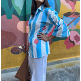 Blue striped dress by Poppy & Co featuring soft vertical stripes, lightweight fabric, and a relaxed, elegant summer fit.
